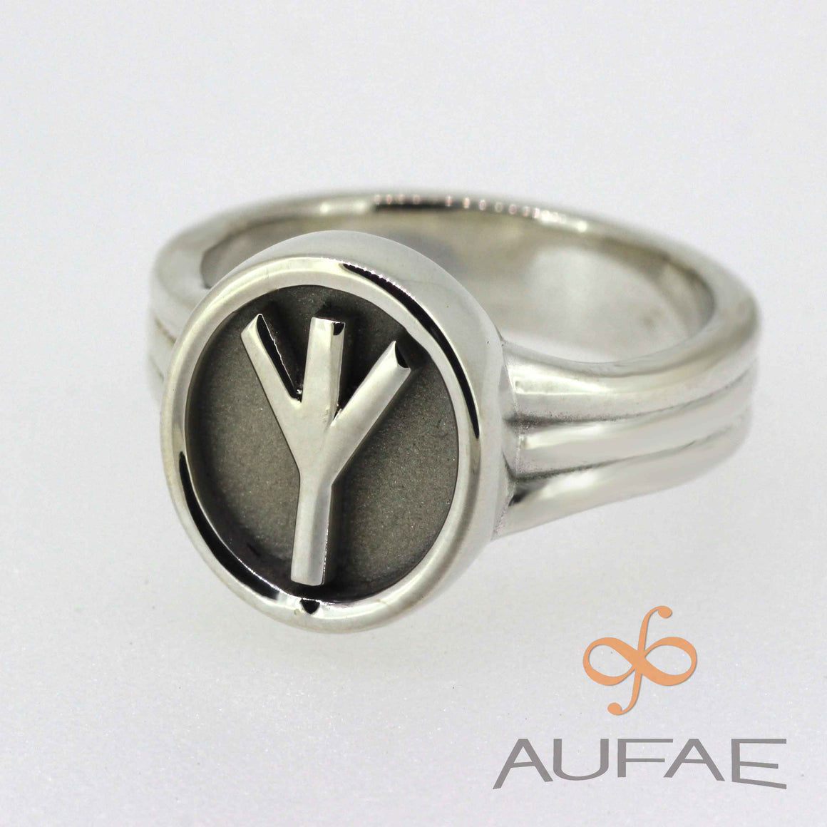 Aufae ALGIZ Rune Ring in solid sterling silver.  Symbolizing protection, this rune is polished sterling silver on a textured sterling background.  The textured background will patina to a pleasing dark color with age.