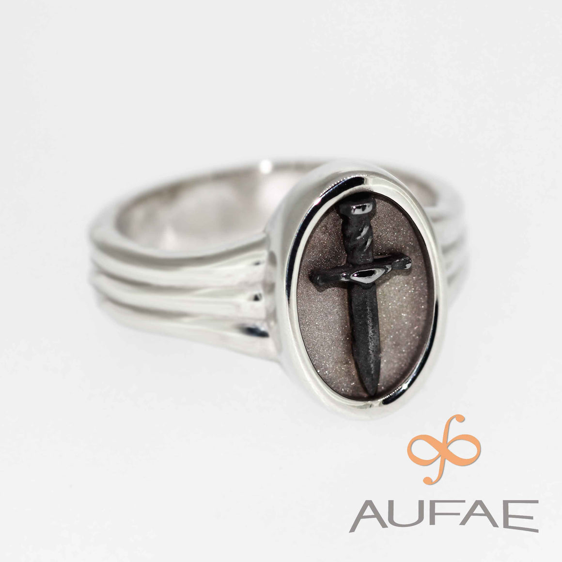 Aufae Dagger Ring:  A Solid sterling silver ring with an IRON dagger permanently bound to a field of textured sterling silver.  For protection against fairies and spirits